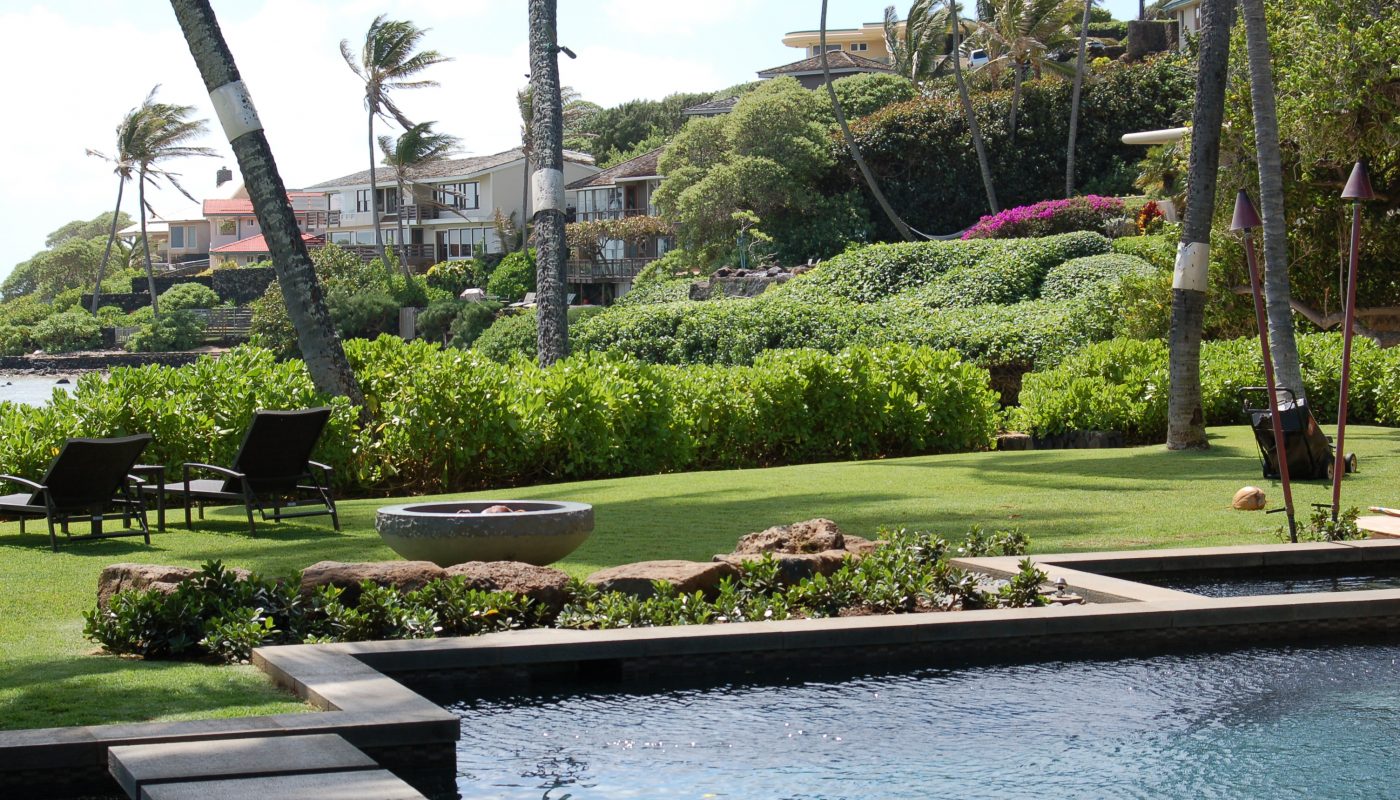 Hardscape and pool border the lawn and gardens