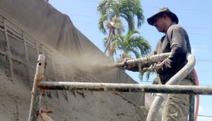 Photo: crew applying shotcrete to wall