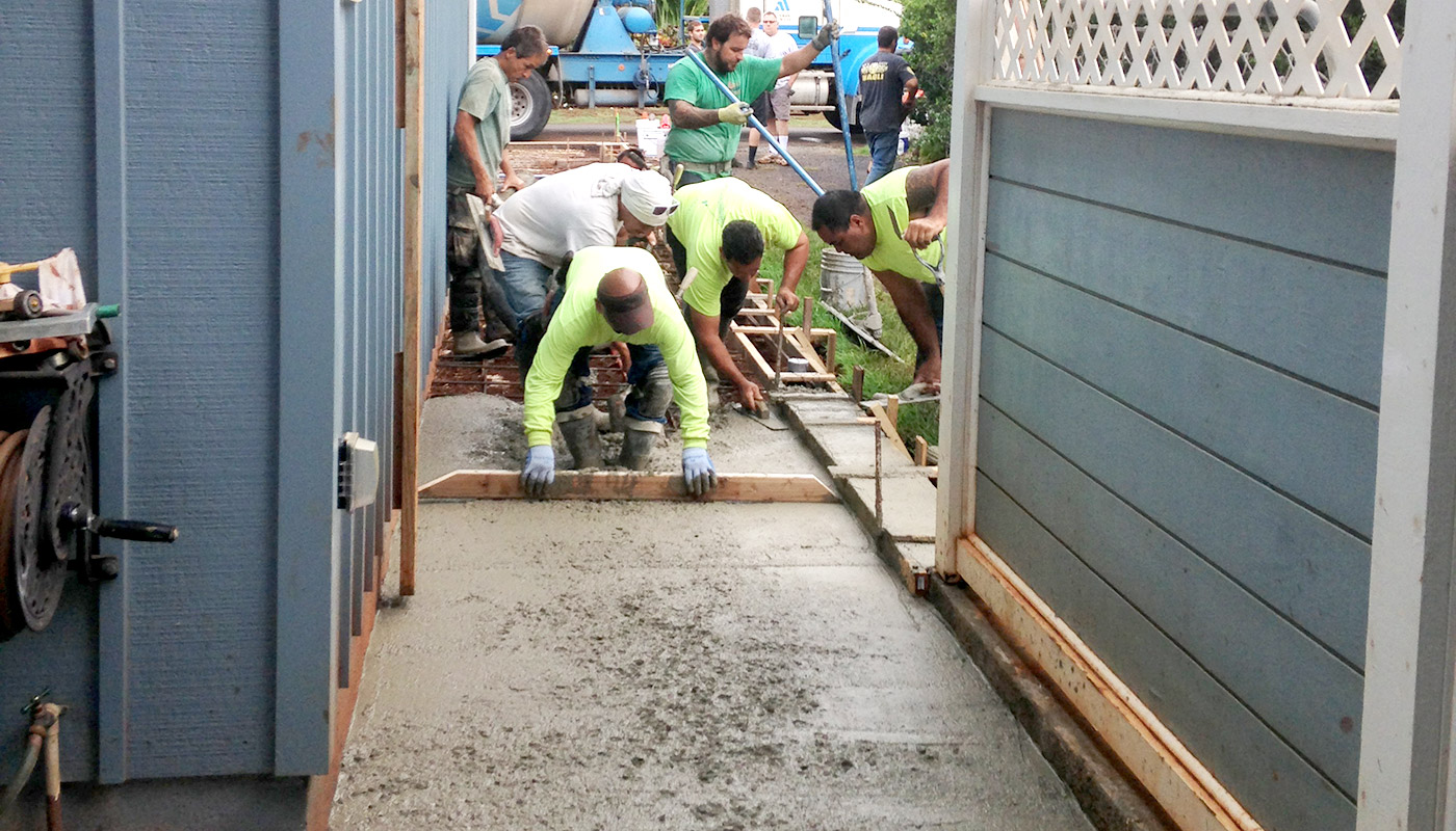 Photo: crew prepares fresh concrete to receive its finished texture