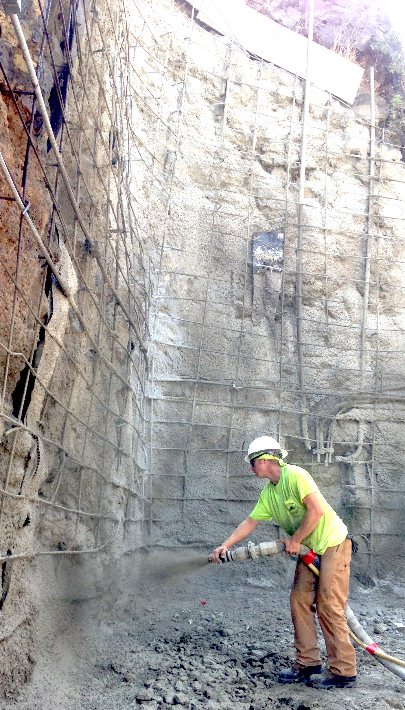 Photo: spraying a tall, shotcrete retaining wall for stabilizing hillsides