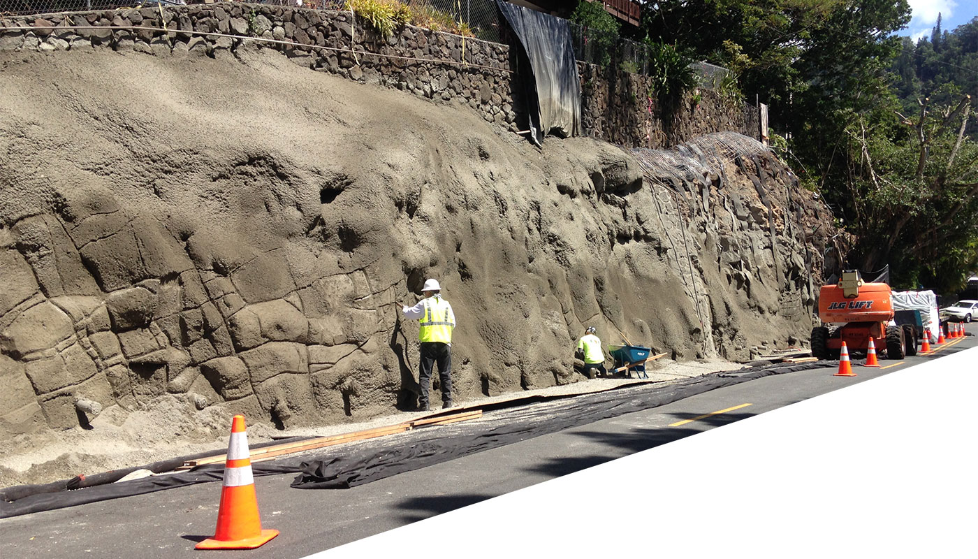 photo: shotcrete for hillside stabilization, with very beginning of decorative modeling