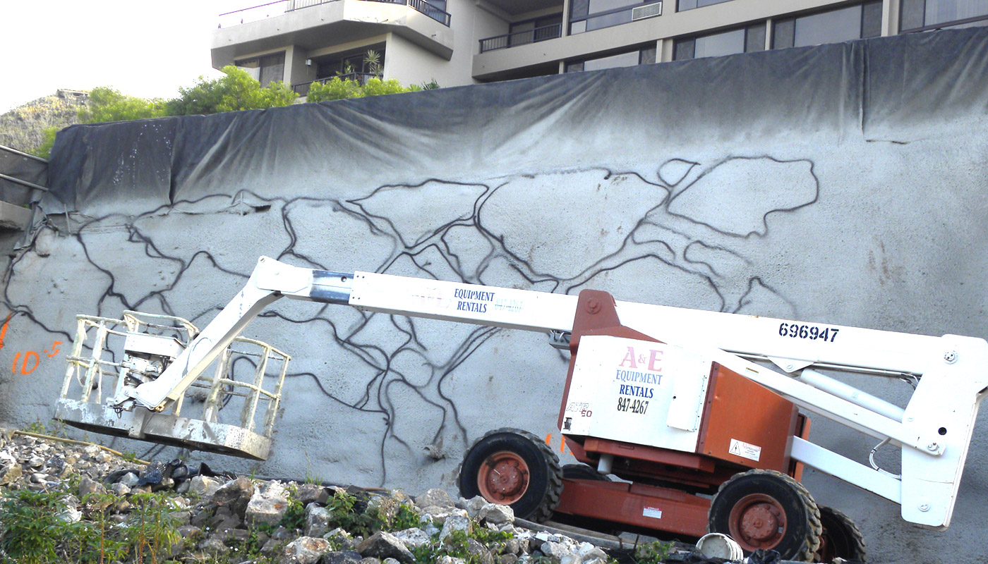 Photo: new shotcrete retaining wall with initial pattern of faux stones incised