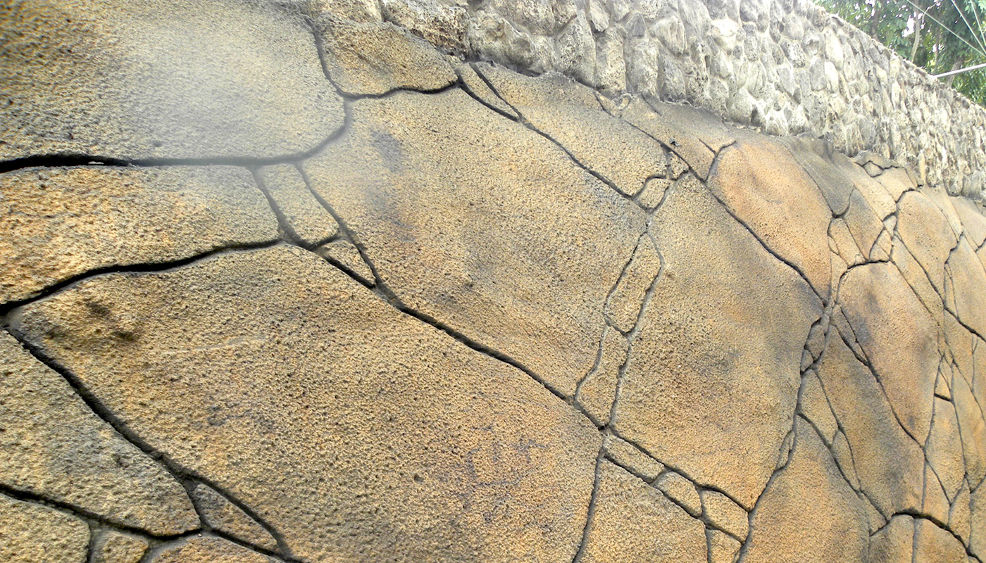 Photo: final color and texture of this low-relief faux stone shotcrete retaining wall