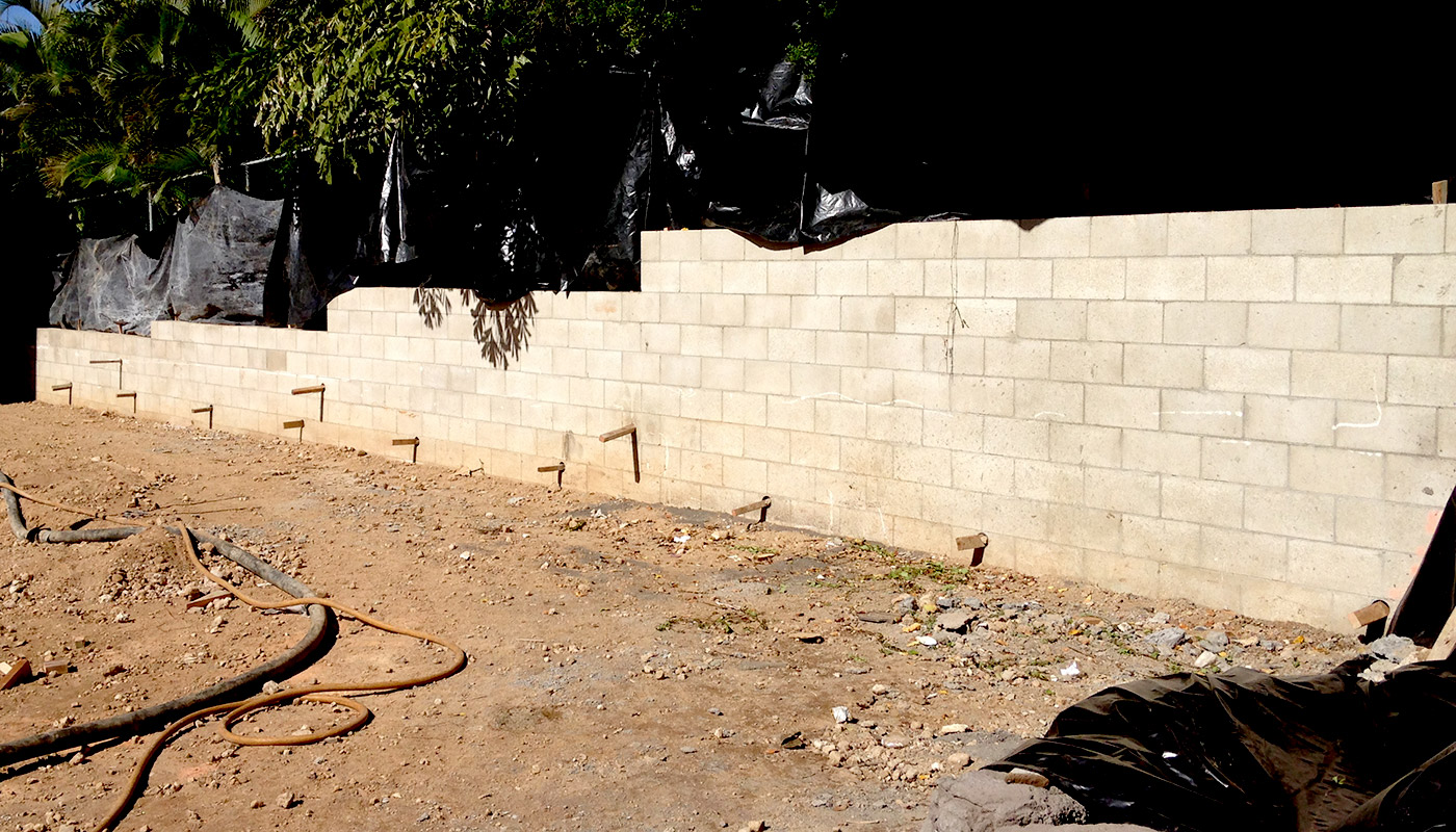 Slideshow: realistic faux stone wall on property boundary.