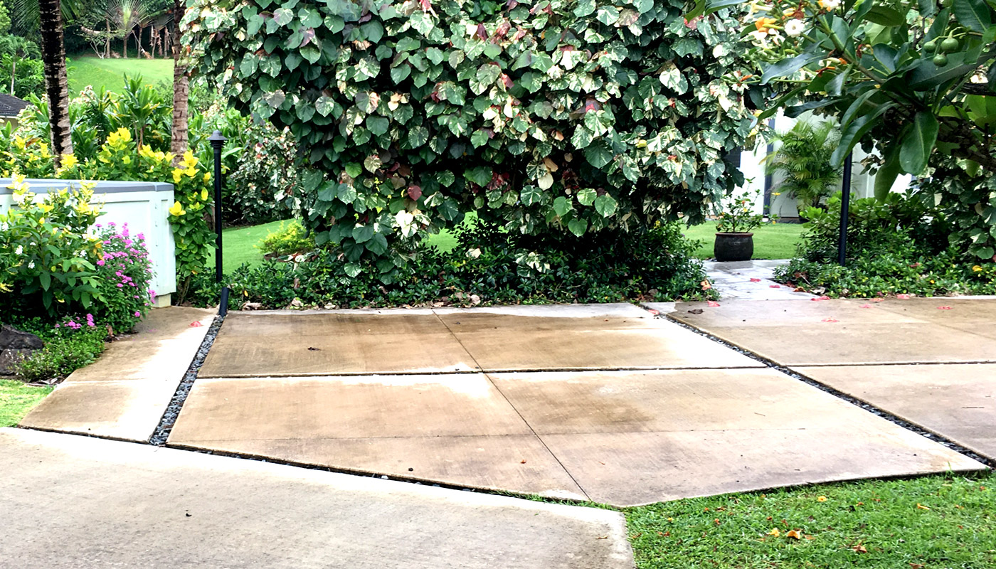 Photo: Angled entry to a residential concrete driveway